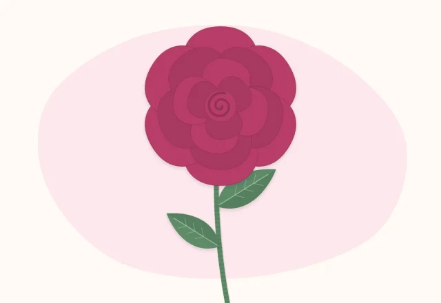 One full crepe paper rose on a wrapped stem with leaves