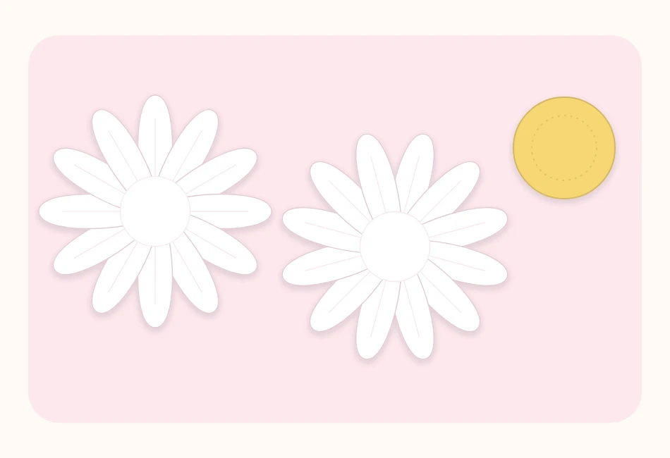 Two white paper circles cut into twelve petals each and a yellow center disc, laid out before assembly