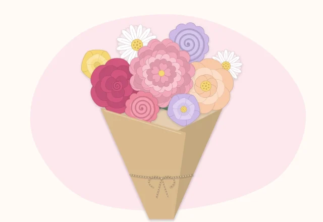 A round hand-tied paper flower bouquet wrapped in kraft paper