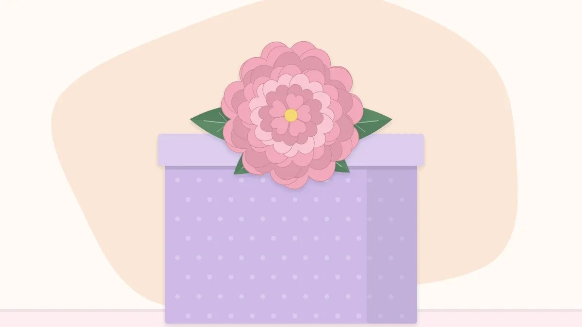 A wrapped gift box topped with a paper flower and two paper leaves instead of a bow
