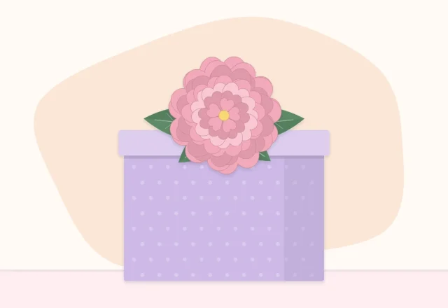 A wrapped gift box topped with a paper flower and two paper leaves instead of a bow