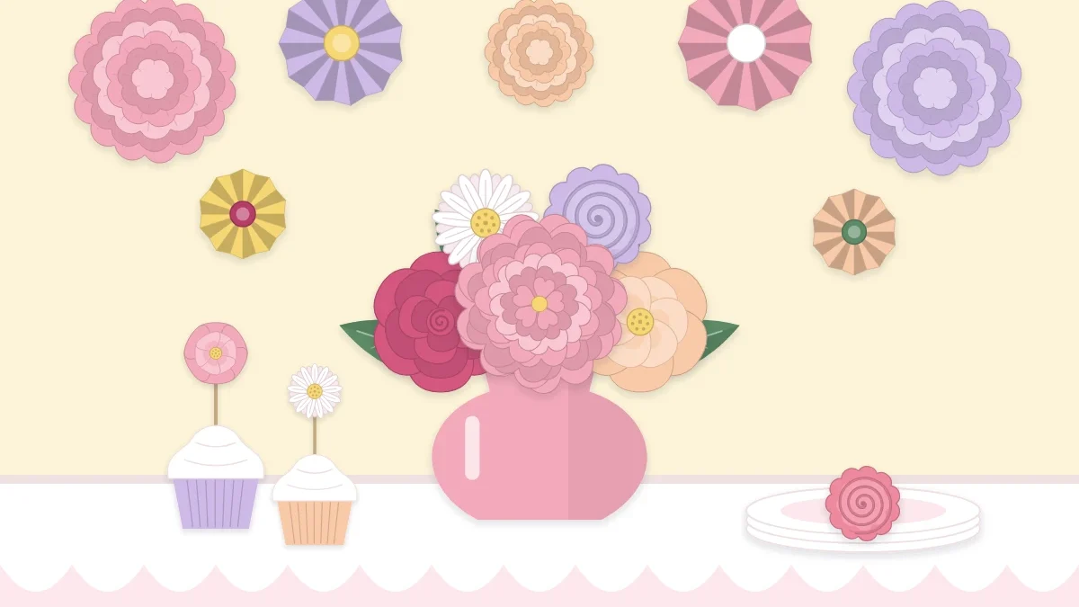 Party table with a paper flower centerpiece and a cluster of paper flowers on the wall behind it
