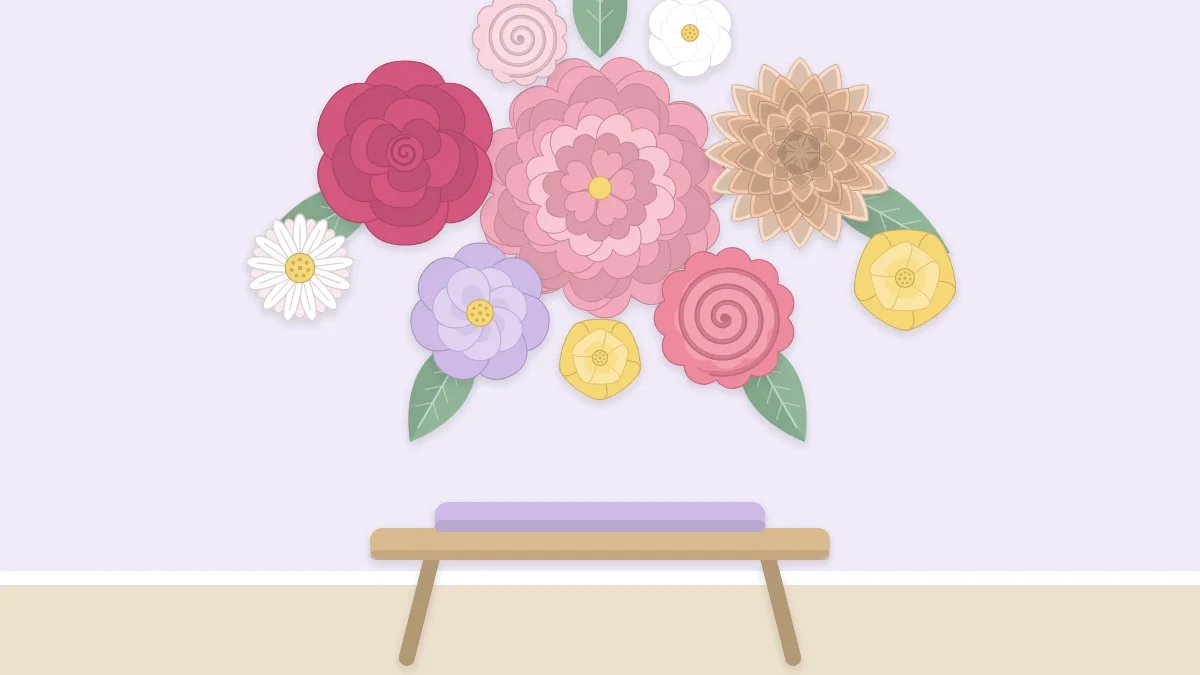A wall decorated with a cluster of paper flowers in several sizes above a small bench