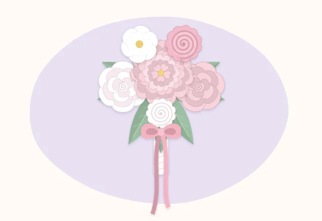 A white and blush paper flower bridal bouquet with long ribbon tails