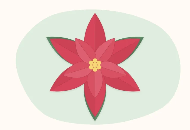 A red paper poinsettia with green leaves and a cluster of yellow beads at its center
