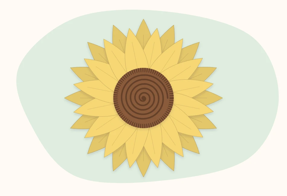 A rolled brown fringed center sitting on top of two stacked rings of yellow paper petals