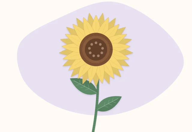 A finished paper sunflower with a green stem and two leaves