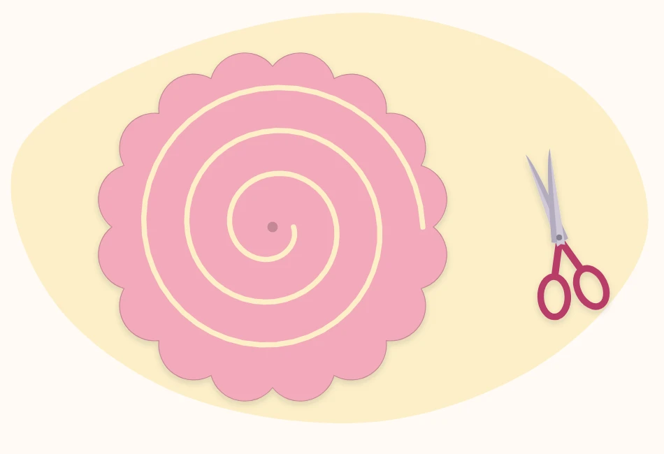 Pink paper circle cut into a spiral with a wavy outer edge and a round tab left at the center