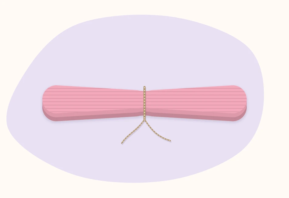 Stack of tissue paper accordion-folded into a strip, tied at the center with both ends cut into rounded shapes
